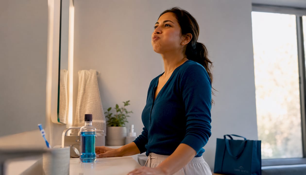 Woman rinsing mouth with antiseptic mouthwash