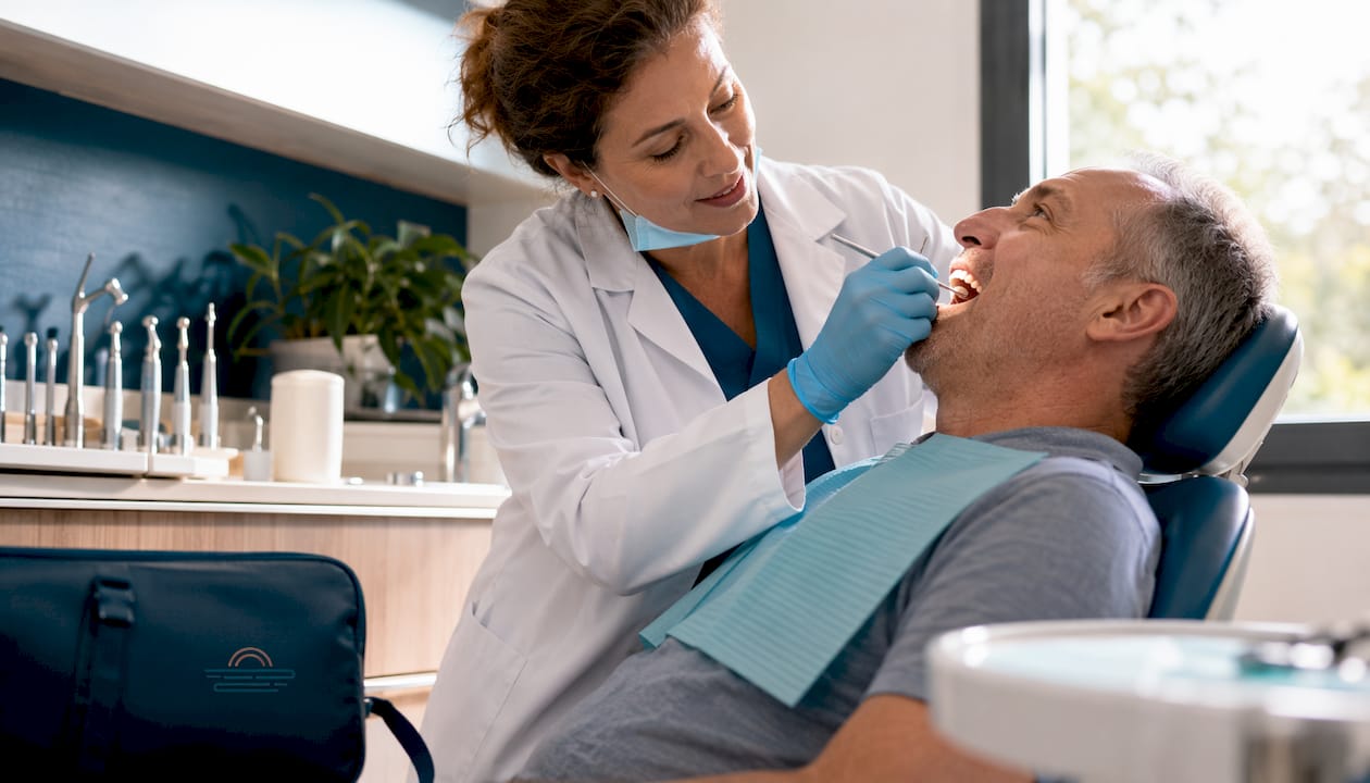 Dentist examining dental bridge in clinic