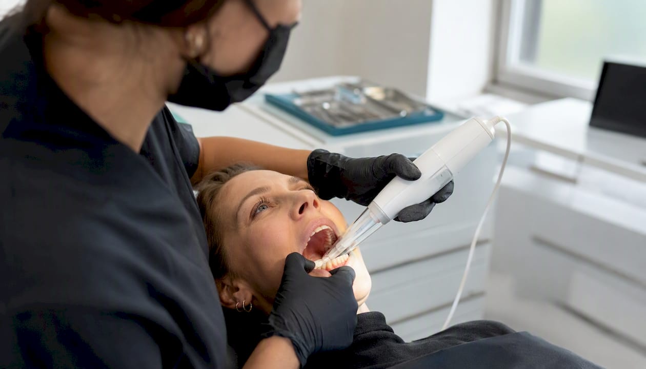 Dentist taking digital impression for custom night guard